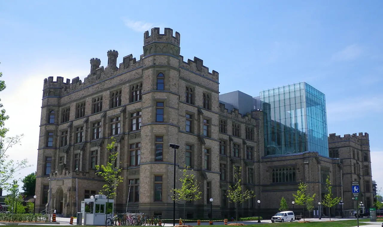 The stone towers and glass Queens Lantern of the Canadian Museum of Nature in Ottawa beneath a blue sky