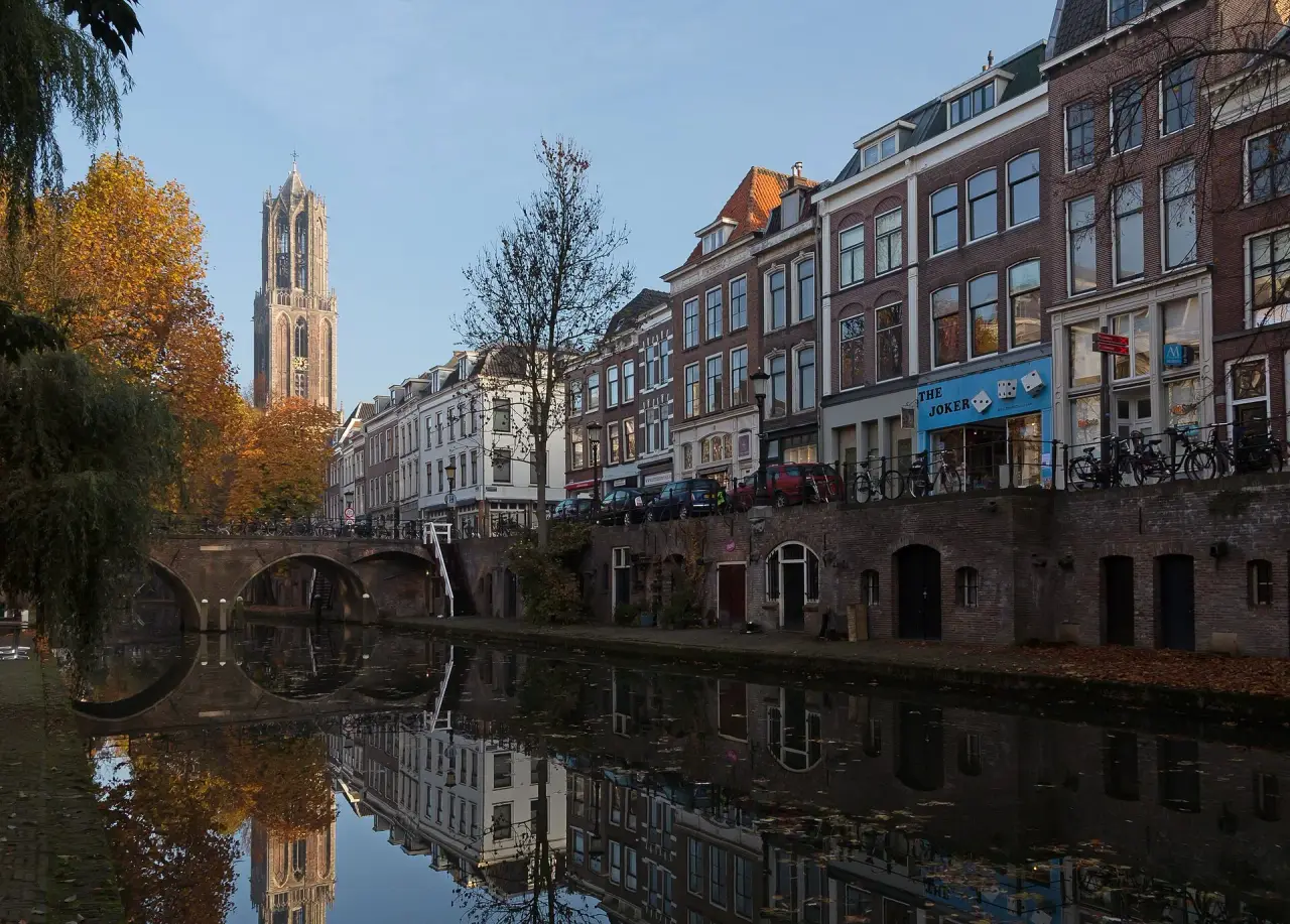 The Dom Tower above Utrecht’s Oudegracht canal and autumn trees