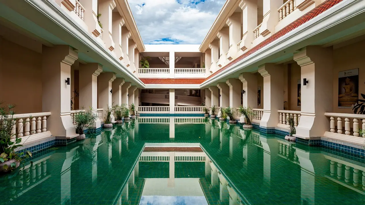 The bright courtyard pool and surrounding cream-coloured galleries of Angkor National Museum in Siem Reap.
