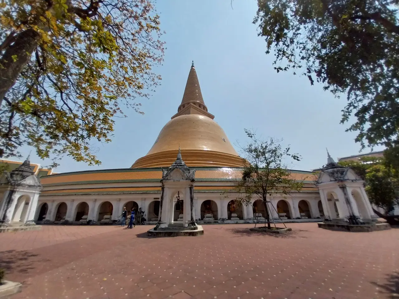 Phra Pathom Chedi rises above its white arcaded enclosure and courtyard in Nakhon Pathom.