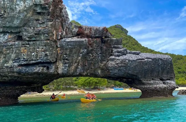 Paddling through a limestone arch in Ang Thong Marine Park