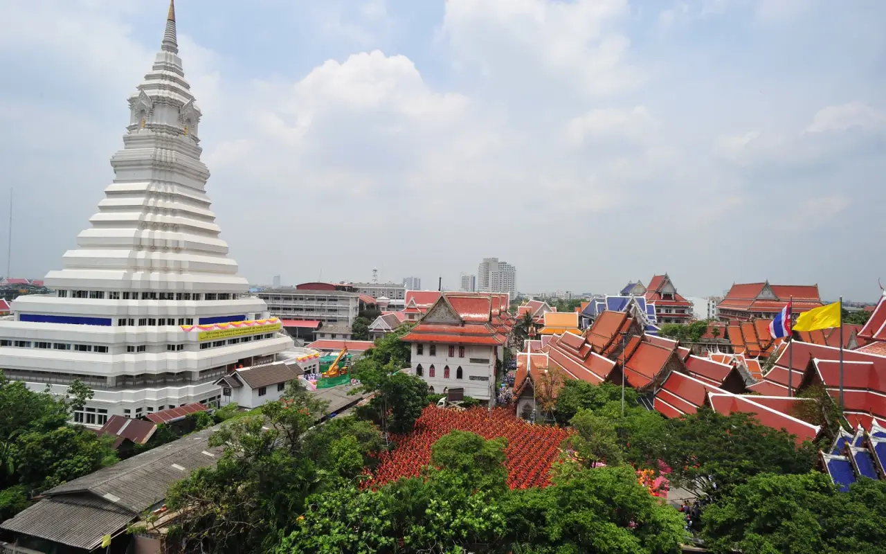 The white stupa and colourful temple roofs of Wat Paknam in Bangkok