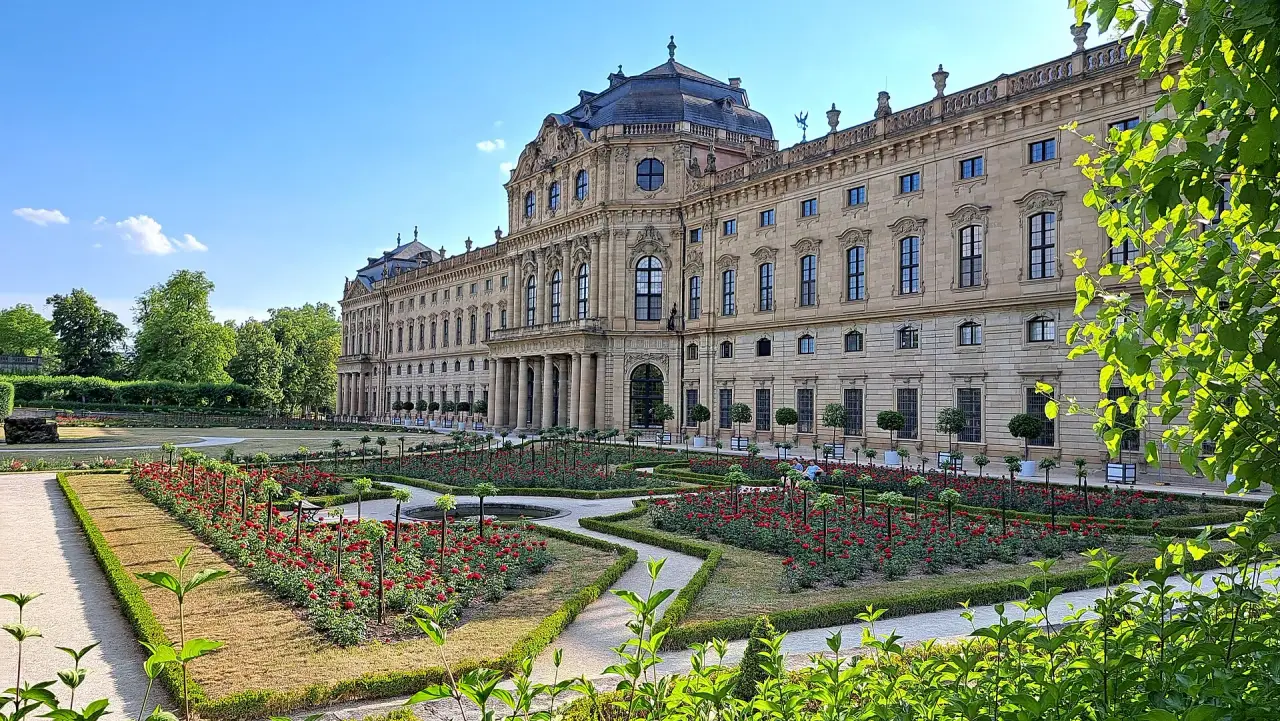 The garden facade of Würzburg Residence above geometric flower beds in the Court Garden