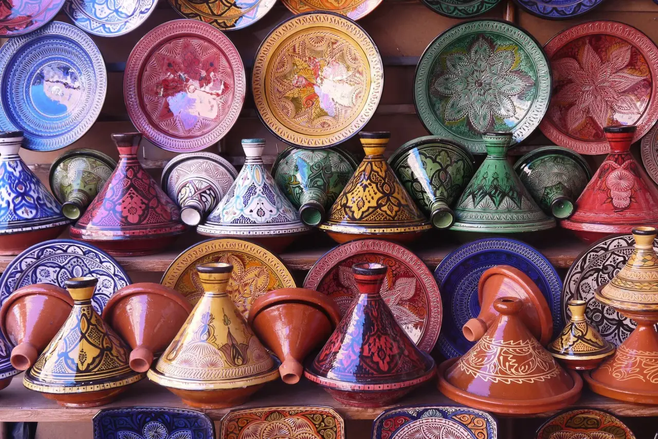 Colourfully painted tagines and plates displayed in a Moroccan pottery shop