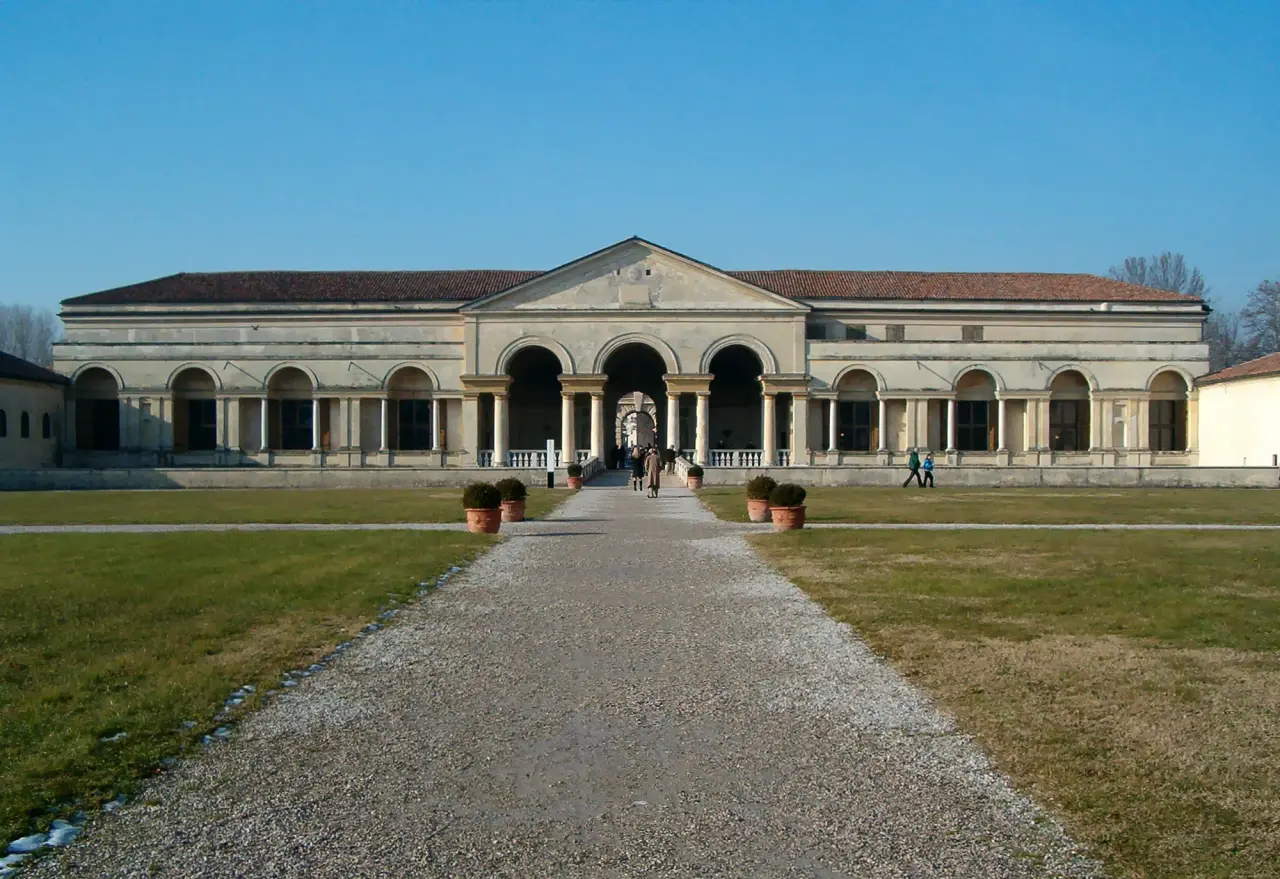 The garden facade and central entrance of Palazzo Te in Mantua beneath a clear blue sky