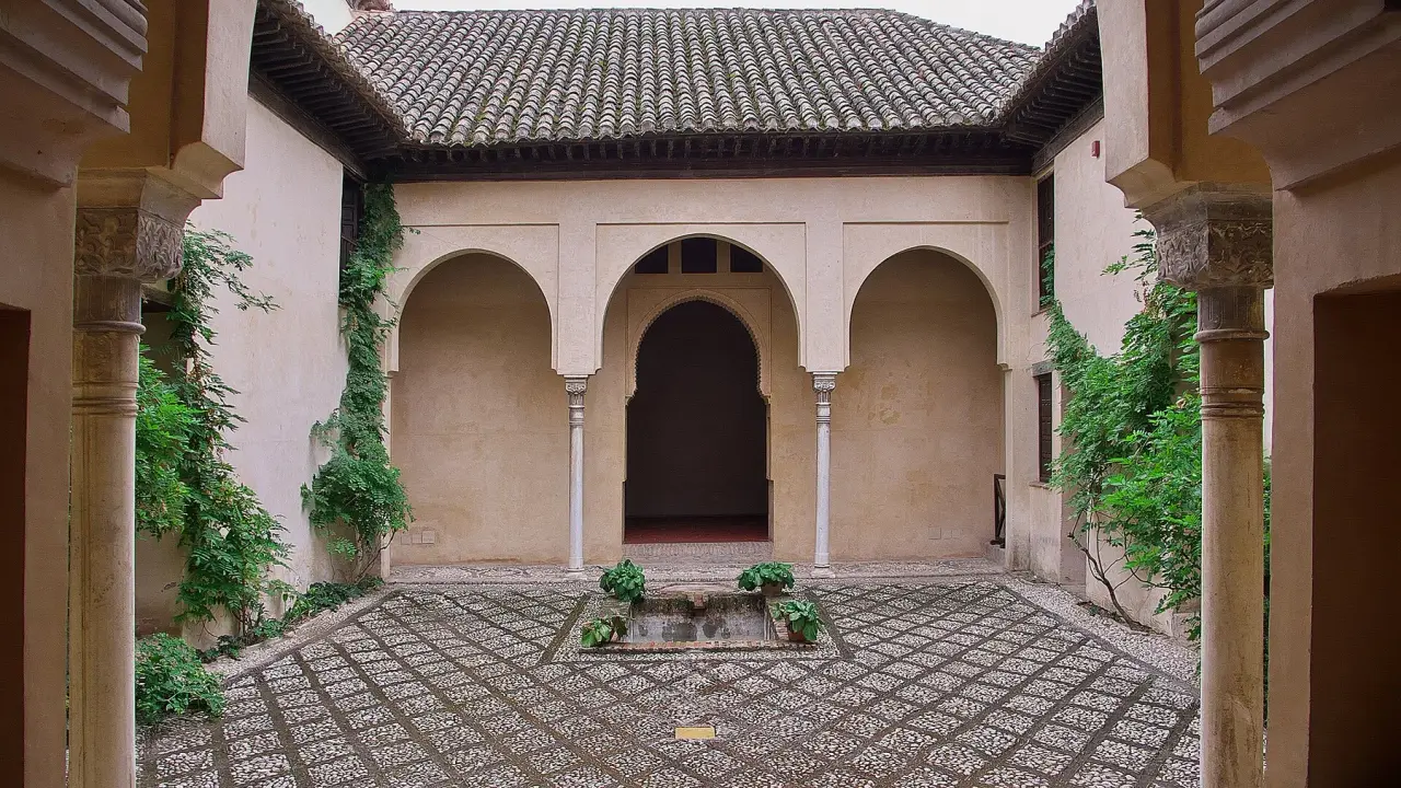 Arched portico and small courtyard fountain at Dar al-Horra Palace in Granada