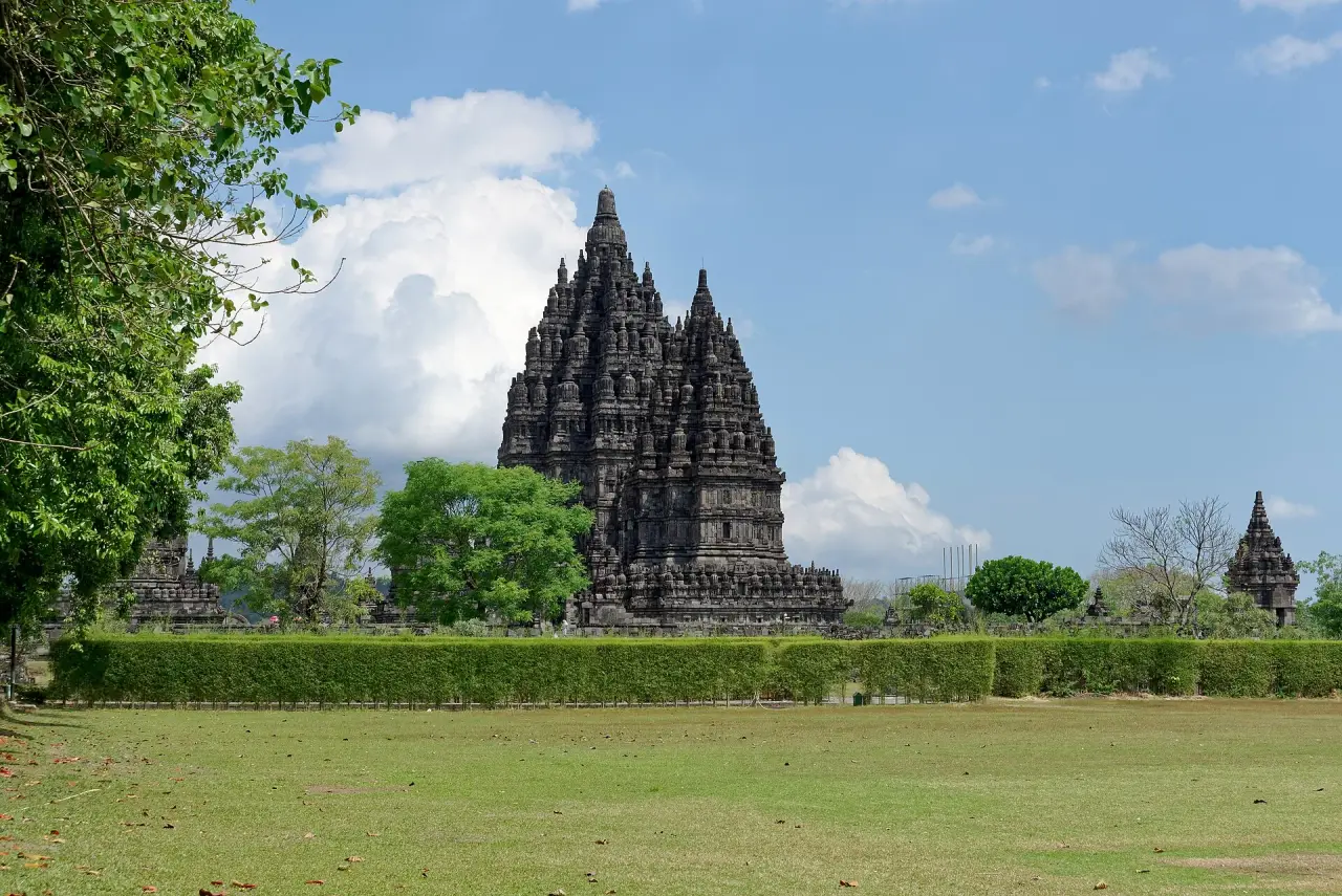 Prambanan’s stone temple towers rising above hedges and lawn near Yogyakarta.