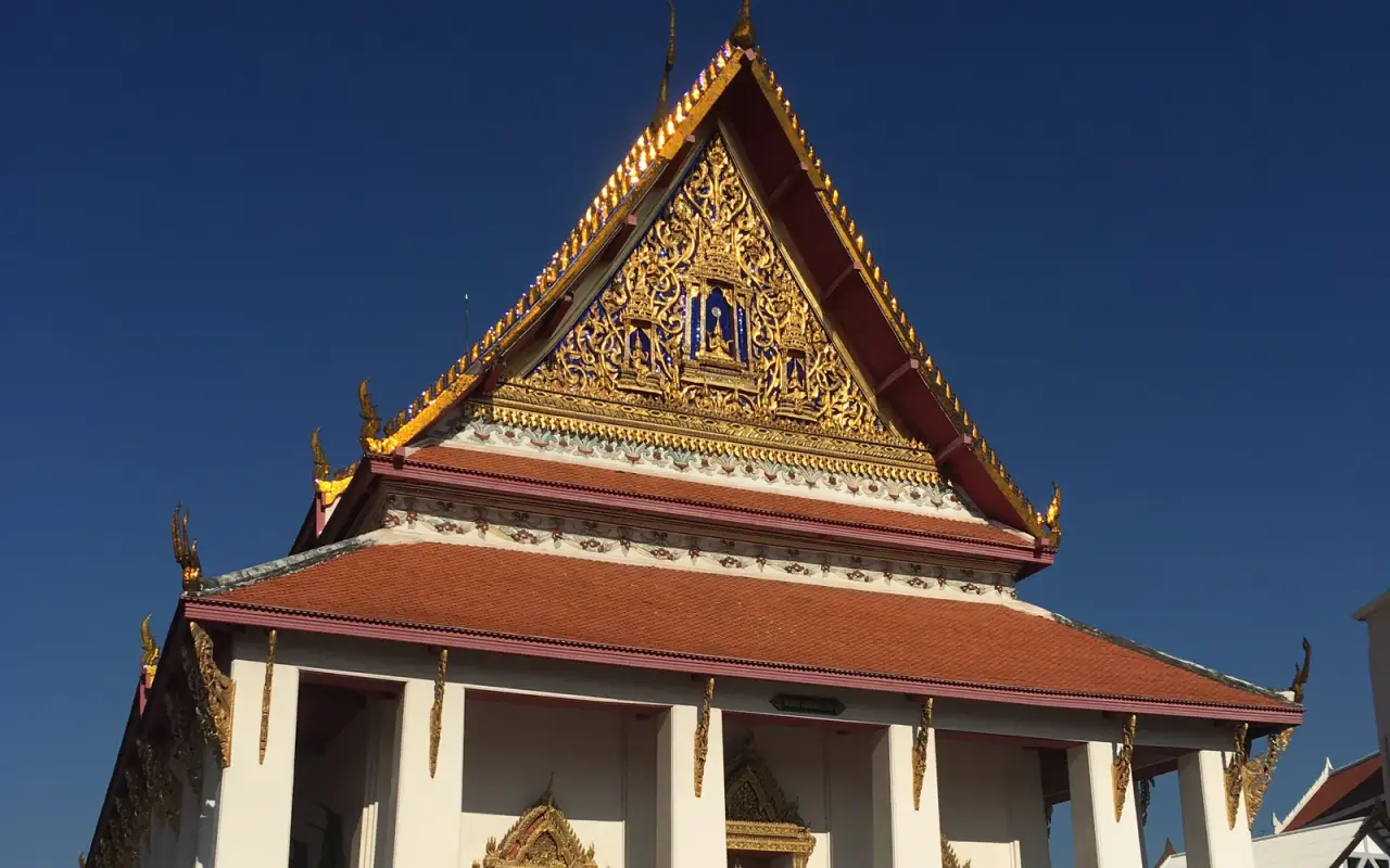 The golden roof and white facade of Phutthaisawan Hall at Bangkok National Museum