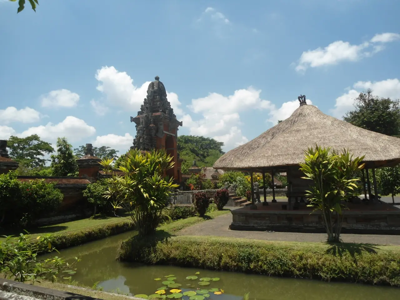 Temple tower, thatched pavilion and garden ponds at Taman Ayun in Mengwi, Bali.