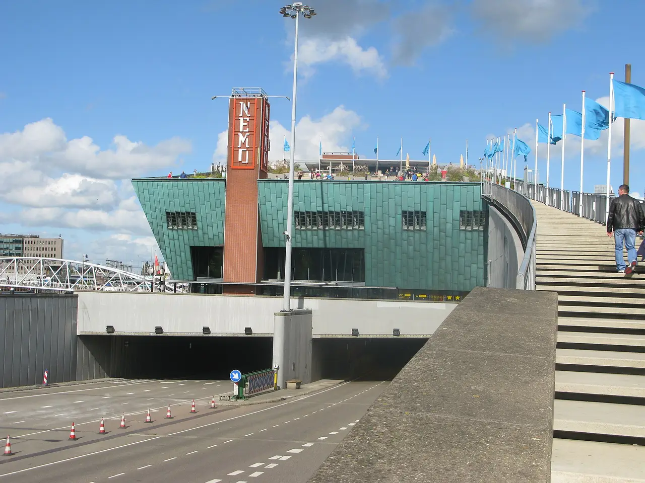 The green NEMO Science Museum building beside the water in Amsterdam.