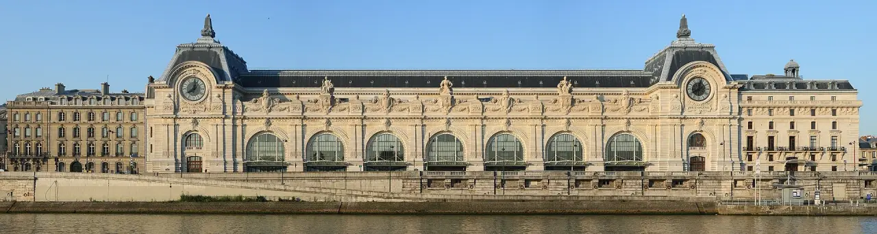 The sunlit Seine-facing facade of the Musée d’Orsay in Paris