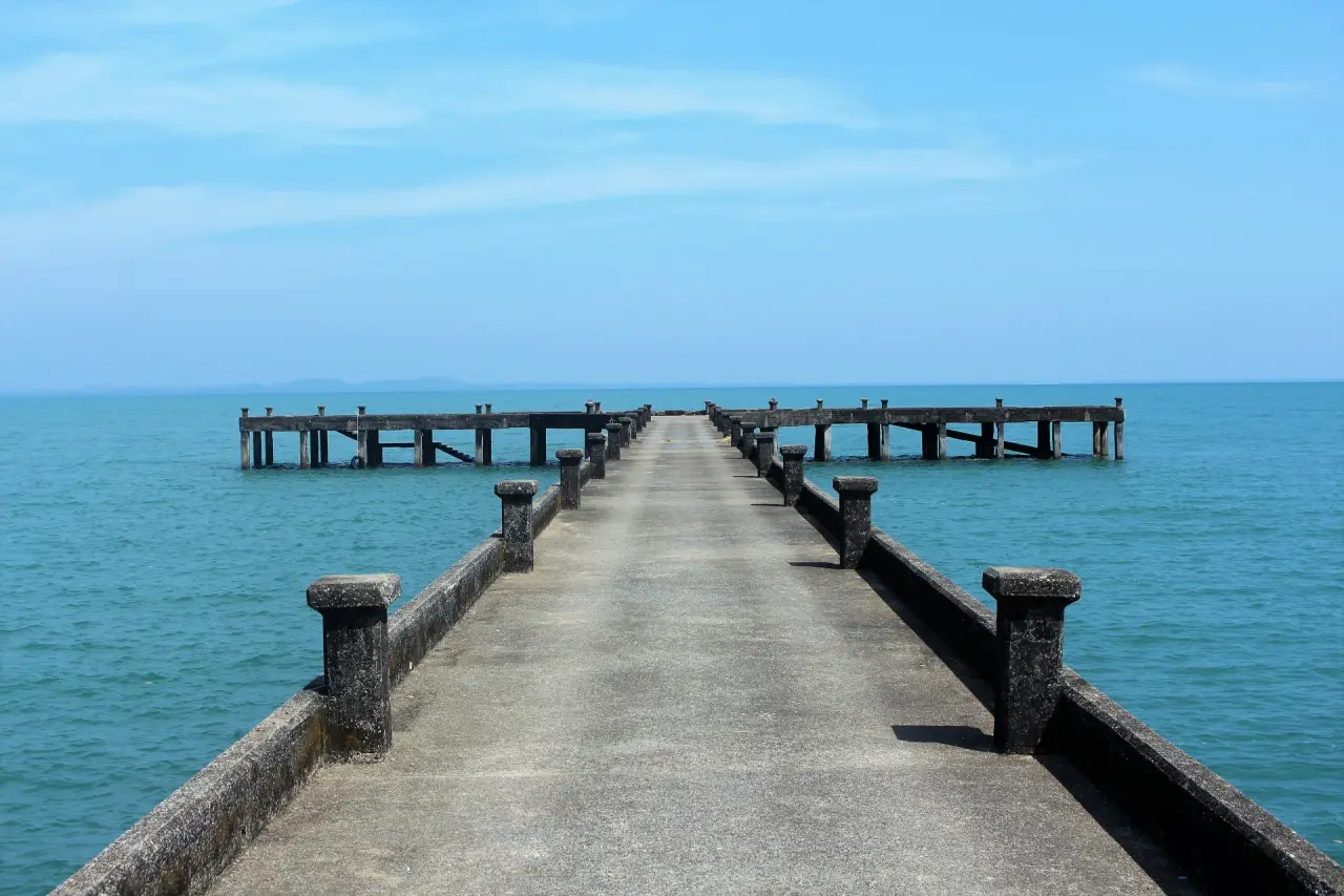 Concrete pier and clear blue sea on the east coast of Ko Chang, Thailand
