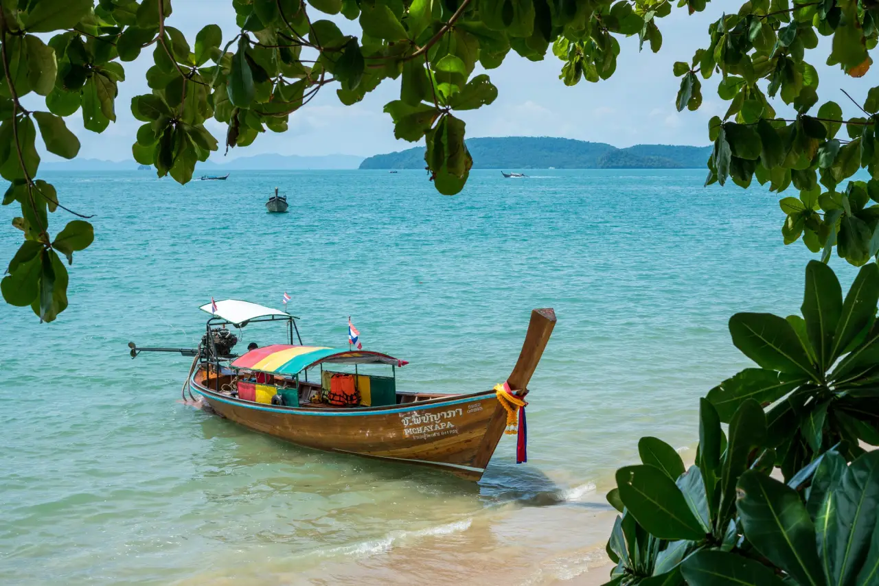 A long-tail boat beside the beach at Ao Nang, Krabi