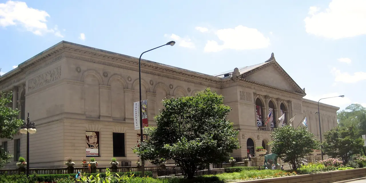 The Art Institute of Chicago’s stone museum façade and complete central pediment behind green planting
