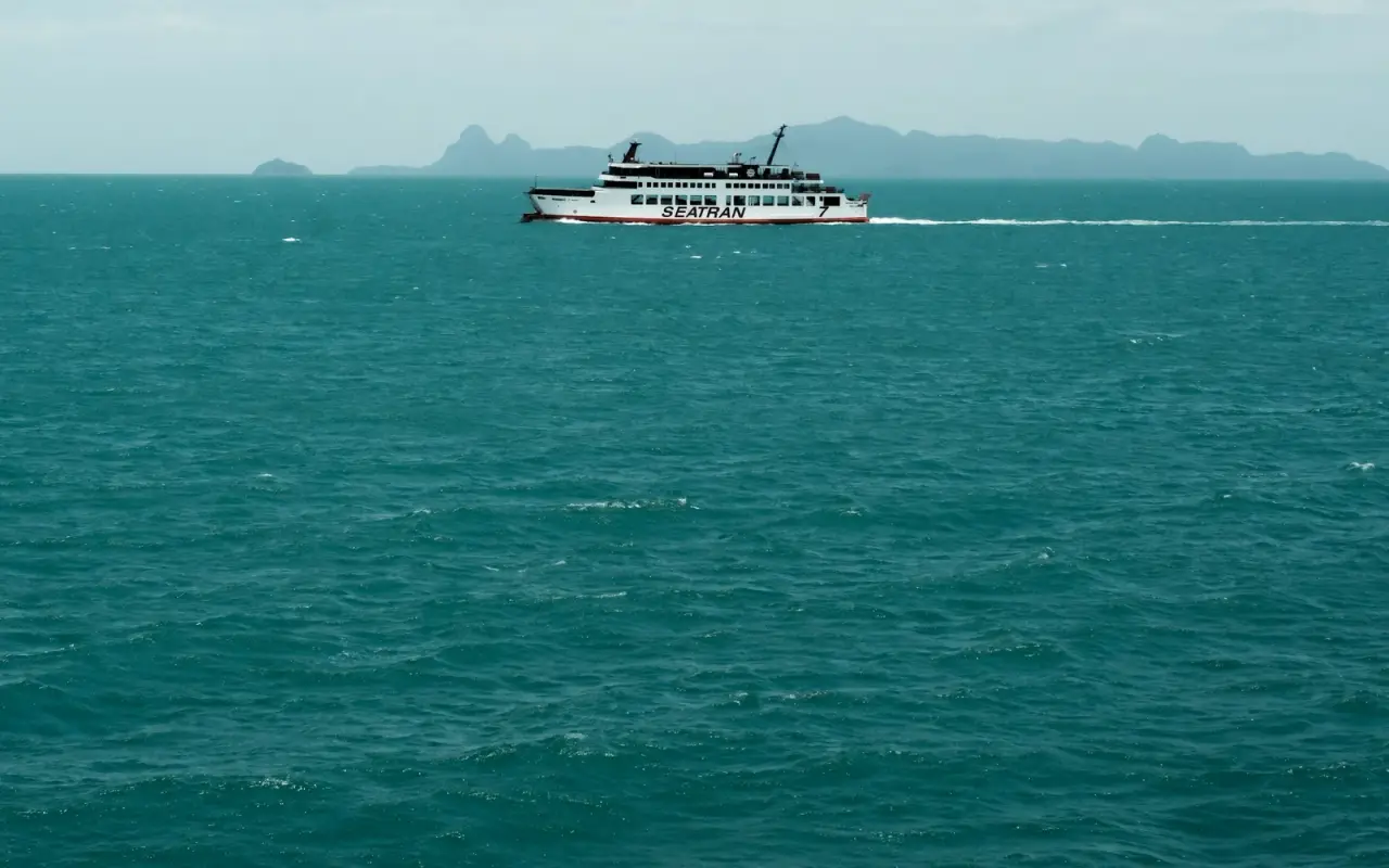 A passenger ferry crossing turquoise sea off Koh Samui