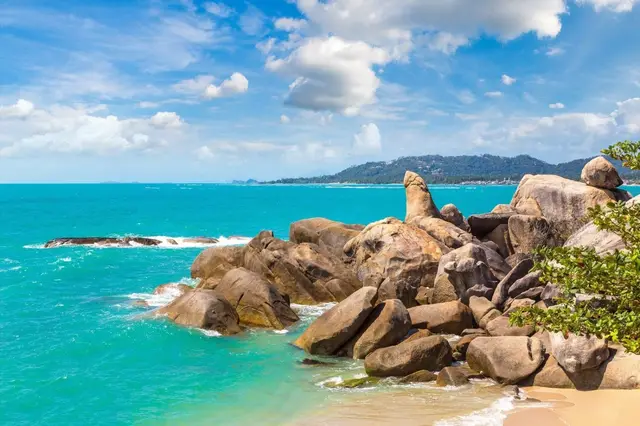 Hin Ta and Hin Yai rocks beside the turquoise sea