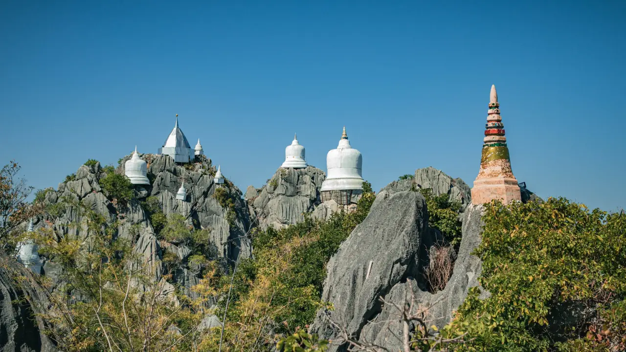 White stupas on rocky summit peaks at Wat Chaloem Phra Kiat in Lampang