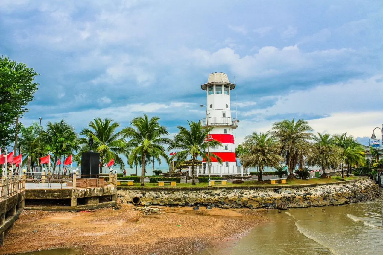 Red and white lighthouse on the waterfront at Laem Ngop in Trat, Thailand
