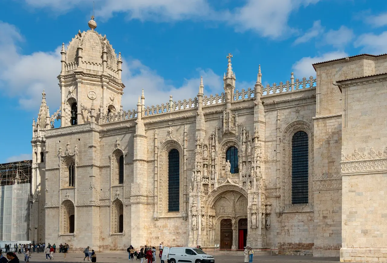 The ornate stone tower and Gothic exterior of Jerónimos Monastery in Belém, Lisbon