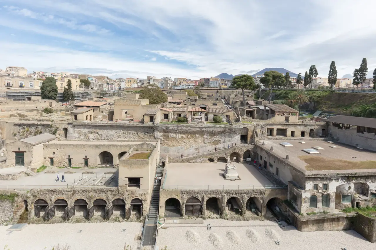 Terraced ruins, surviving walls and vaulted arches in the archaeological park at Herculaneum.