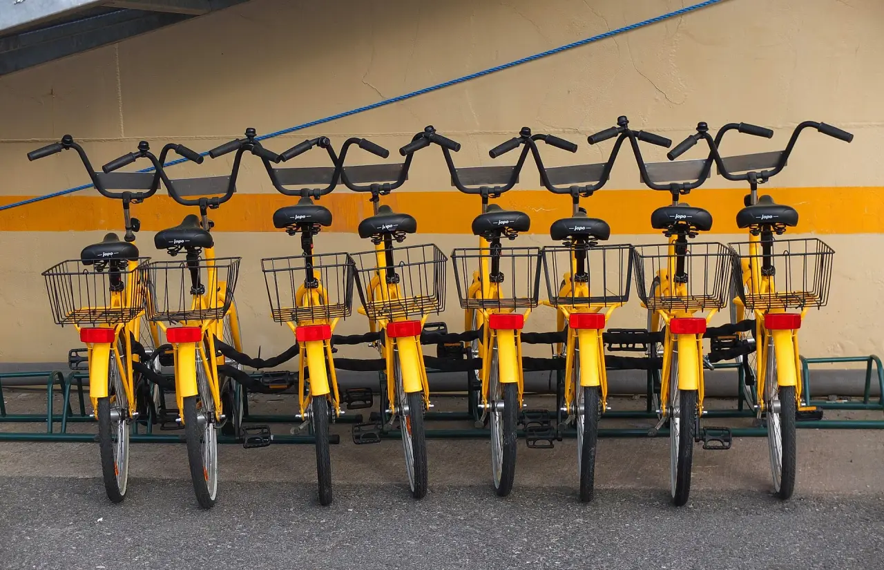 Yellow rental bicycles parked beside the Bore hostel ship in Turku