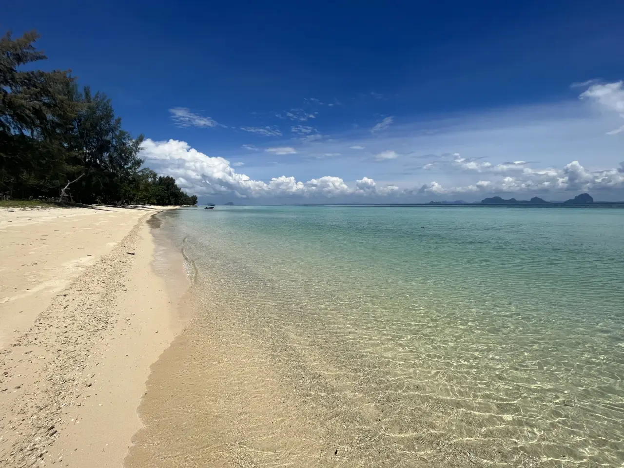 Clear shallow water meeting the sandy shore of Ko Ngai in Thailand