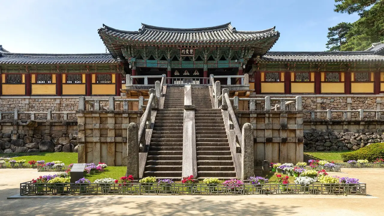 Bulguksa’s Jahamun gate above Cheongungyo and Baegungyo stone stair bridges with bright flowers in Gyeongju